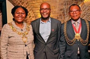 John James shows off his Sickle Cell Society pin, as the mayors of Southwark and Lambeth show off their equally-famous jewellery!